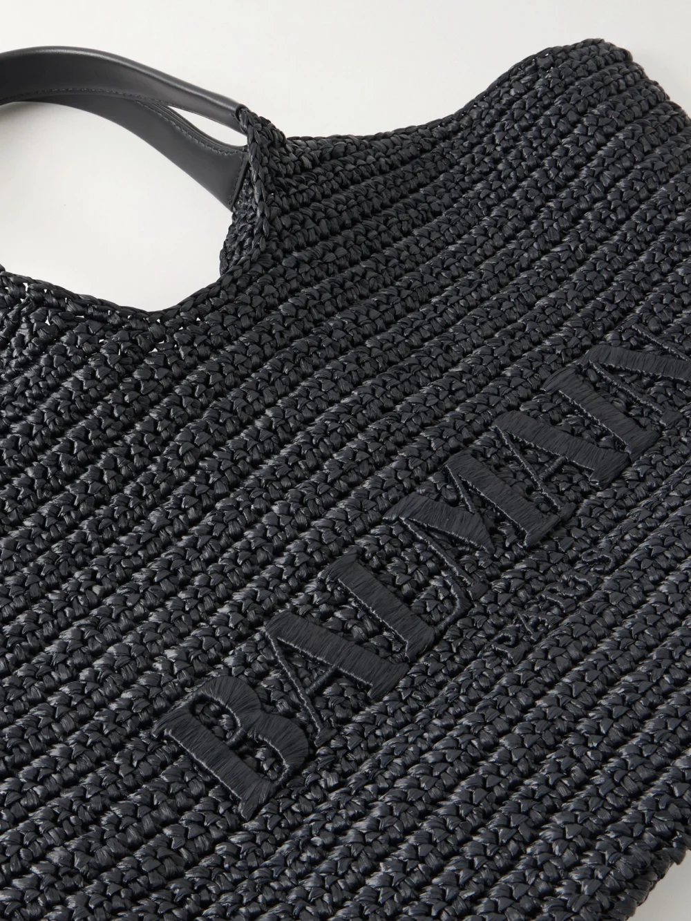 Close-up detail of the Balmain Cabas Large Logo-embroidered Leather-trimmed Raffia Shoulder Bag
