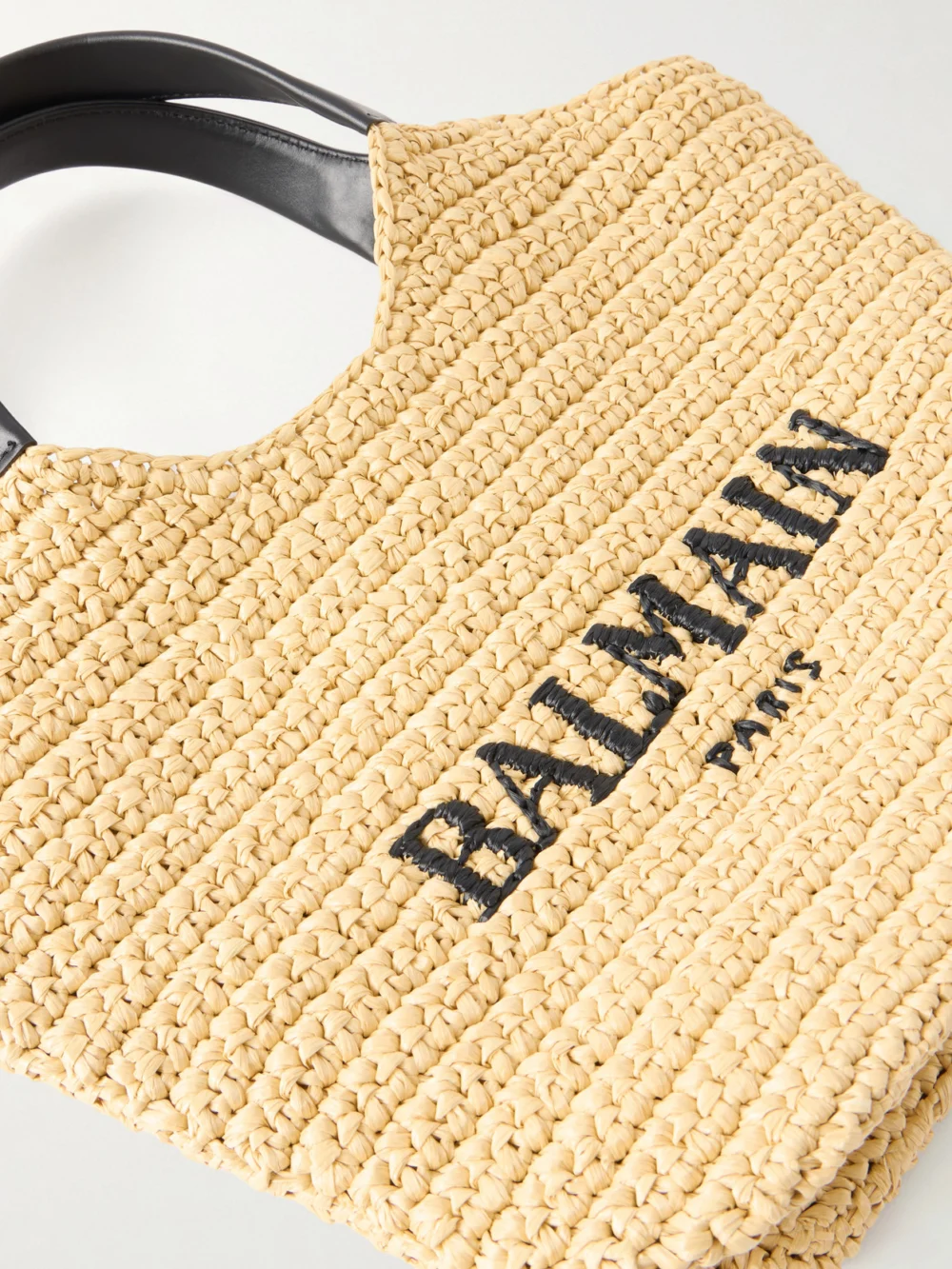 Close-up detail of the Balmain Cabas Mini Leather-trimmed Raffia Shoulder Bag