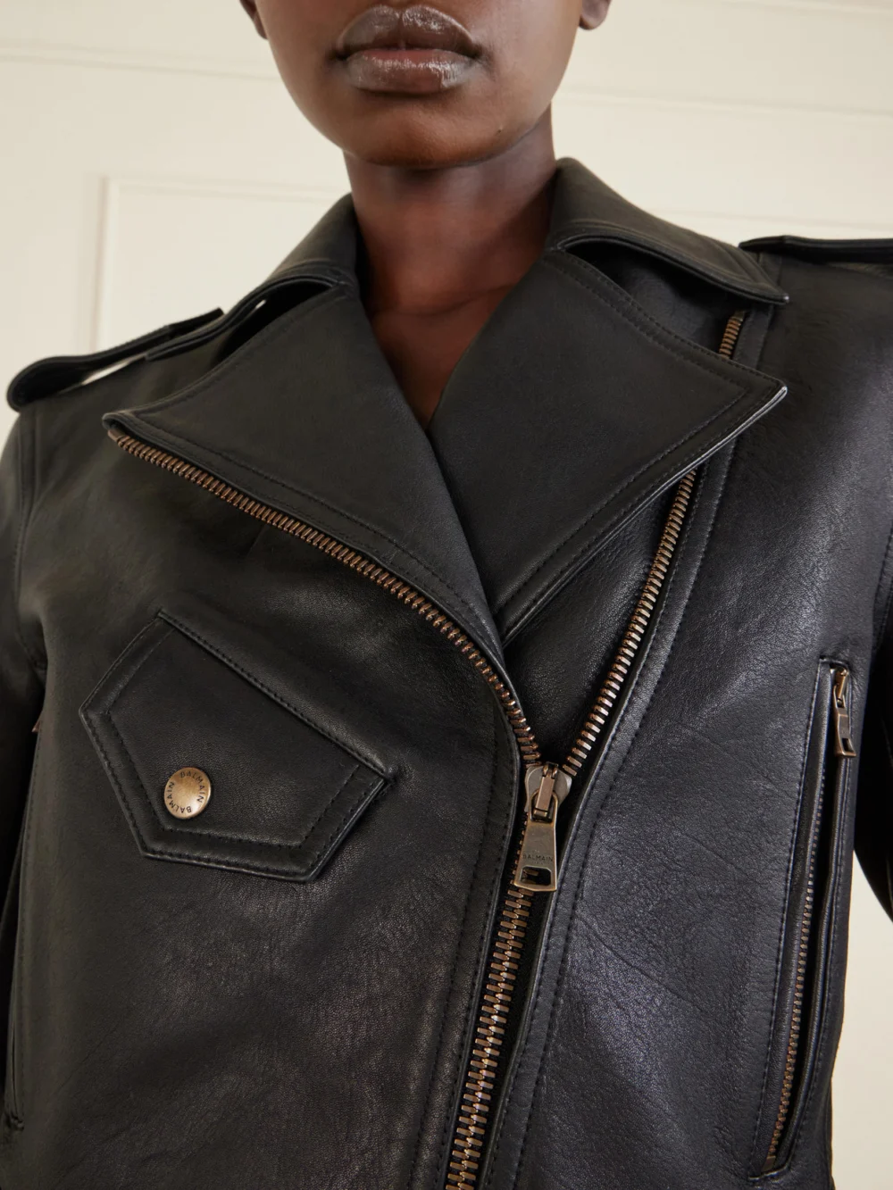 Close-up detail of the Balmain Cropped Belted Leather Biker Jacket