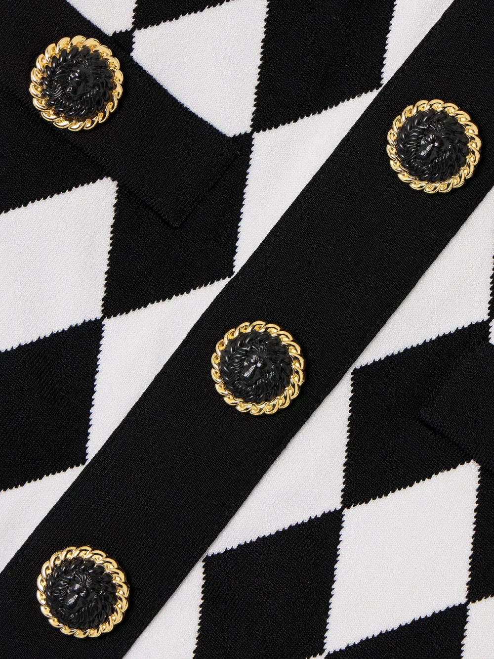 Close-up detail of the Balmain Cropped Button-embellished Jacquard-knit Top