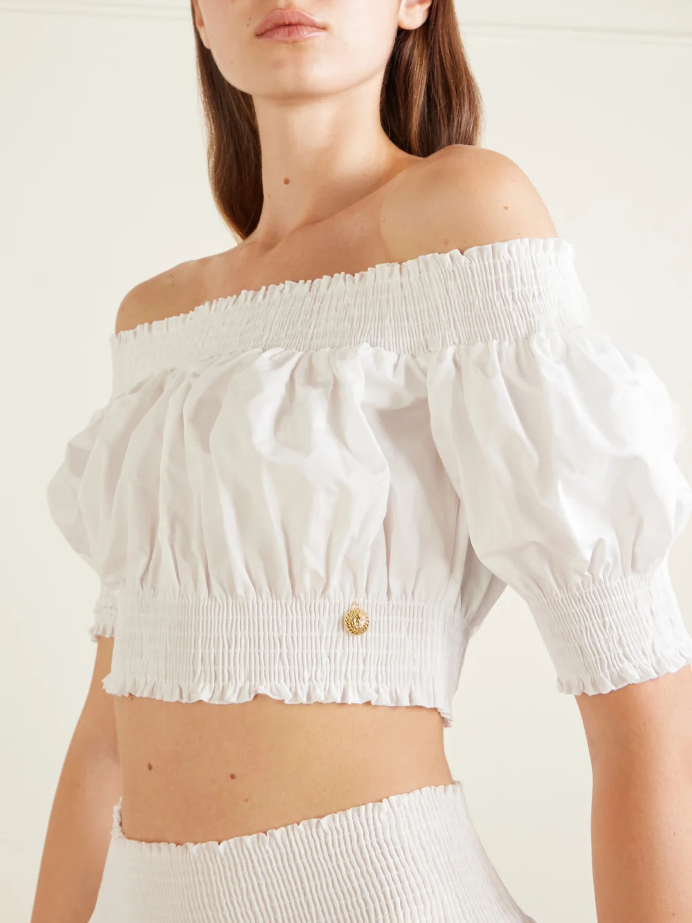 Close-up detail of the Balmain Embellished Cropped Off-the-shoulder Cotton-poplin Top
