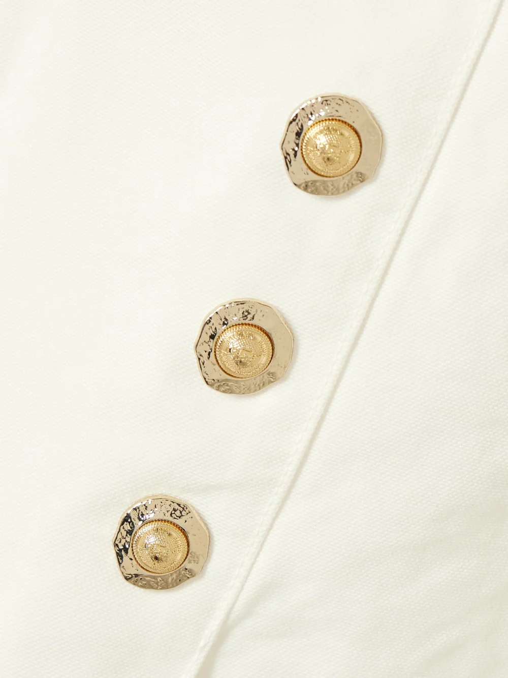 Close-up detail of the Balmain Embellished Pleated Cotton-canvas Mini Skirt