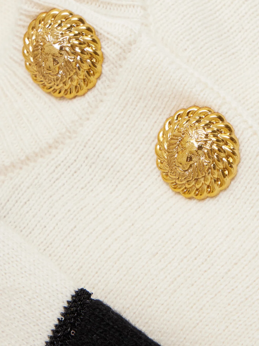 Close-up detail of the Balmain Embellished Striped Knitted Sweater