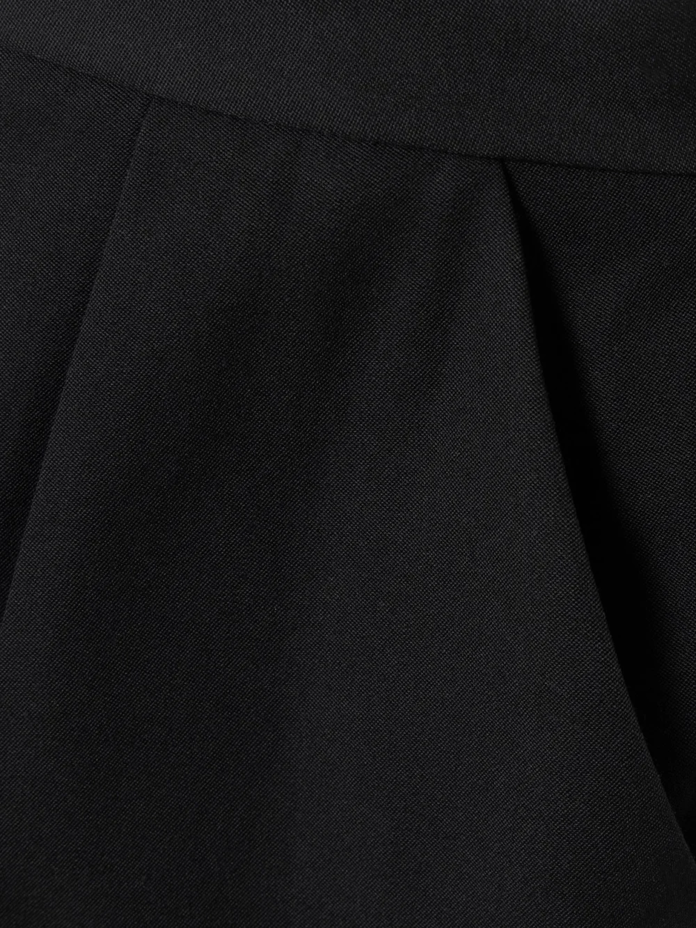 Close-up detail of the Balmain Pleated Grain De Poudre Wool Tapered Pants