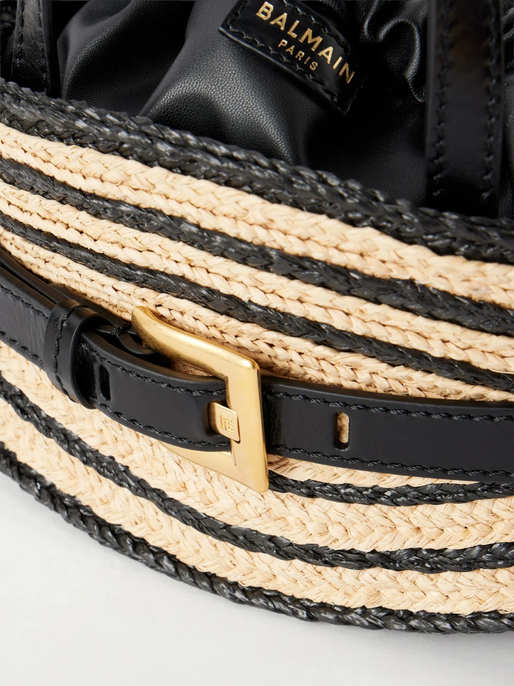 Close-up detail of the Balmain Shuffle Mini Buckled Leather-trimmed Raffia Top-handle Bag