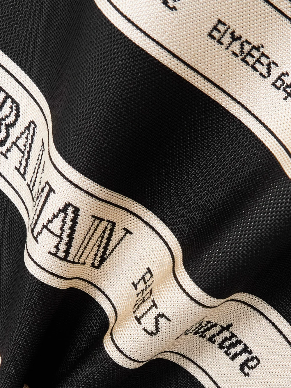 Close-up detail of the Balmain Striped Jacquard-knit Halterneck Mini Dress
