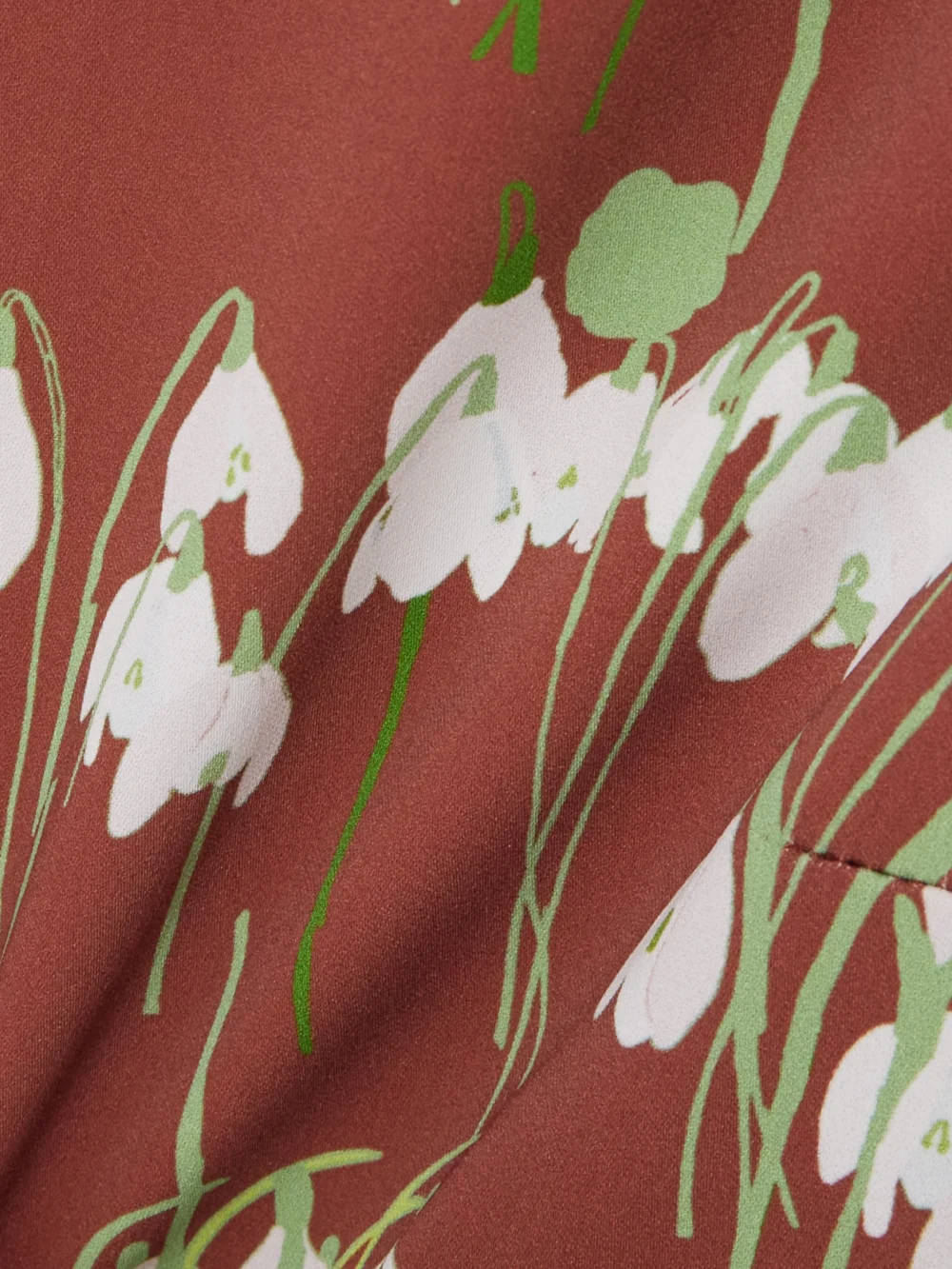 Close-up detail of the Bernadette Lucille Belted Floral-print Crepe Mini Dress