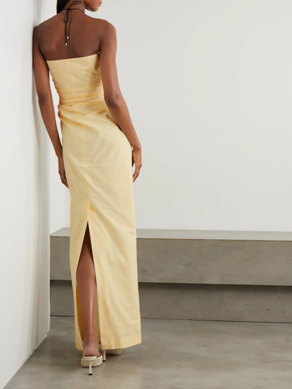 Back view of the Bernadette Vera Strapless Ruched Striped Cotton-seersucker Maxi Dress