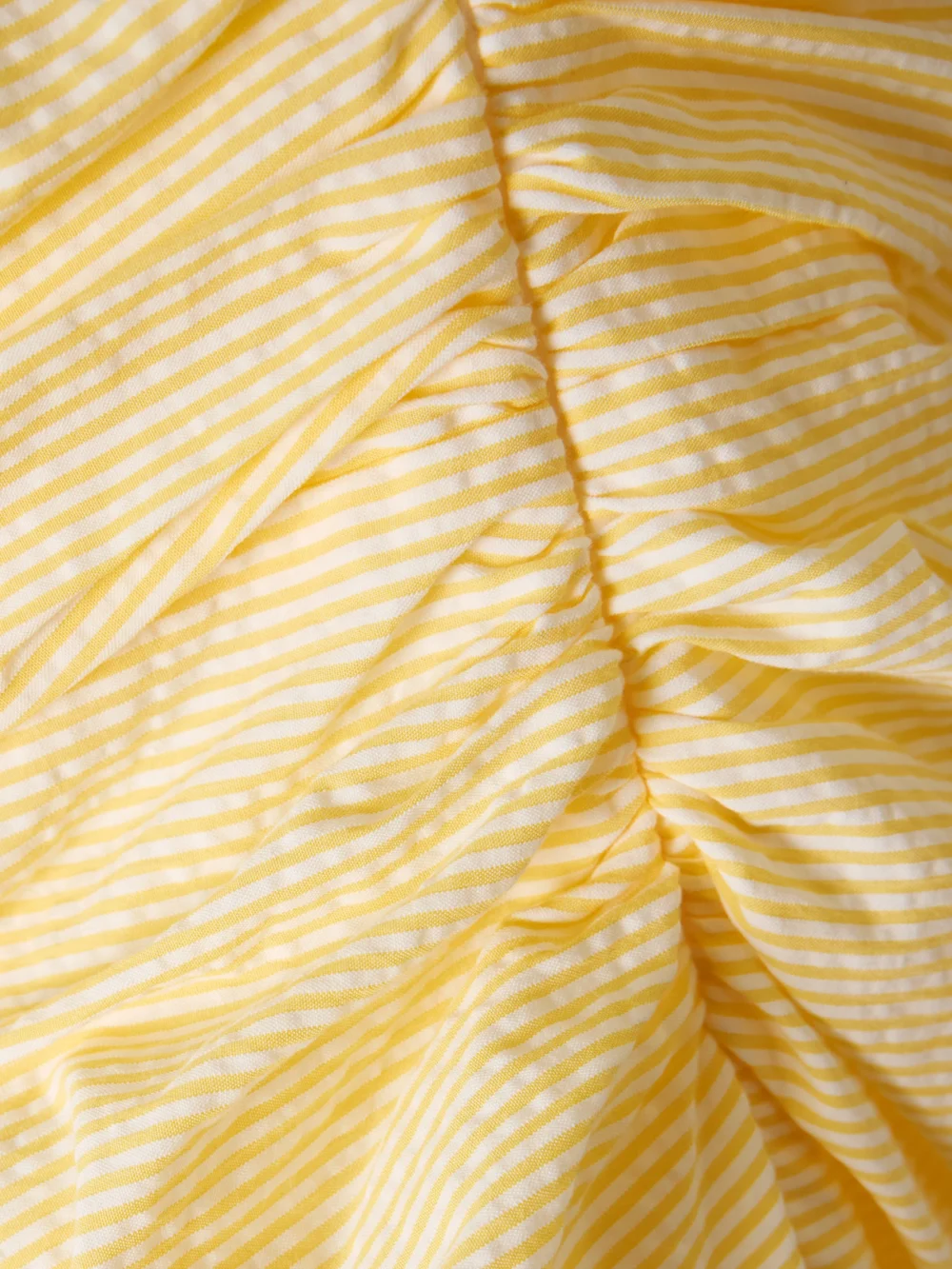 Close-up detail of the Bernadette Vera Strapless Ruched Striped Cotton-seersucker Maxi Dress