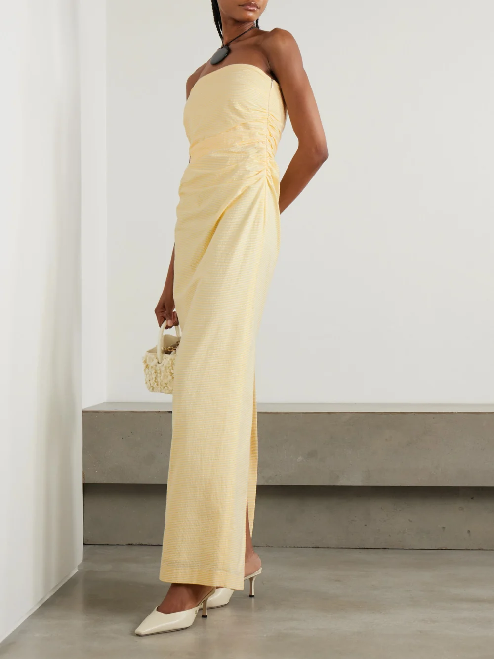 Bernadette Vera Strapless Ruched Striped Cotton-seersucker Maxi Dress, worn by a model