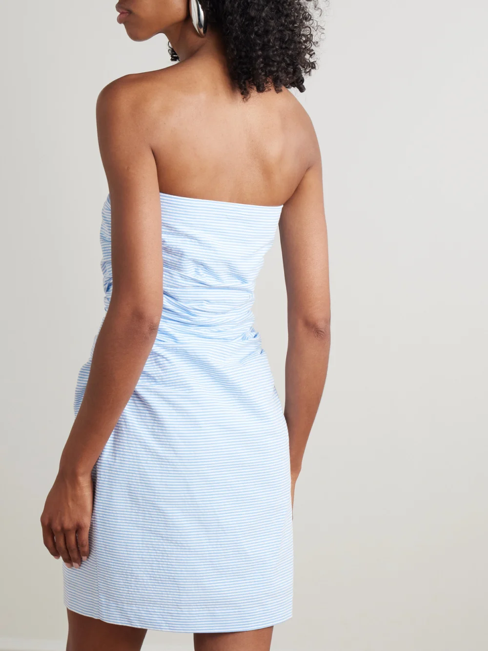 Back view of the Bernadette Vera Strapless Ruched Striped Cotton-seersucker Mini Dress
