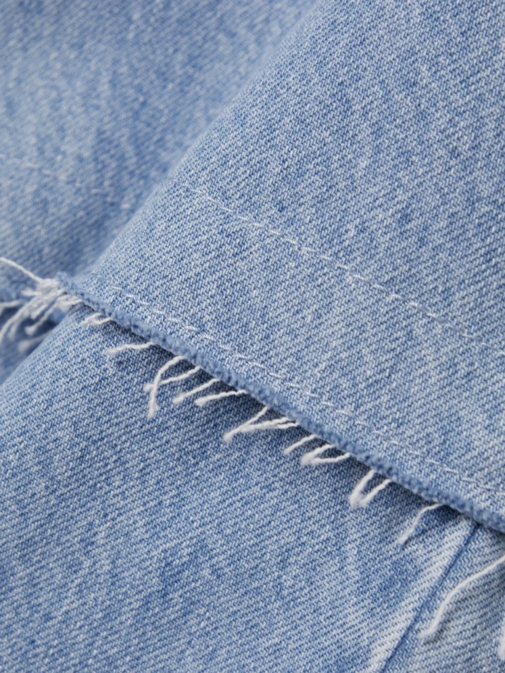 Close-up detail of the Bettter Convertible Frayed Denim Maxi Skirt