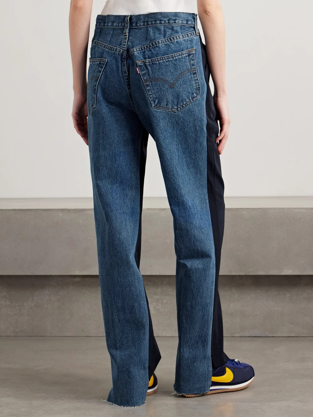 Back view of the Bettter Denitrouser Paneled Pleated Wool-blend and Denim Pants