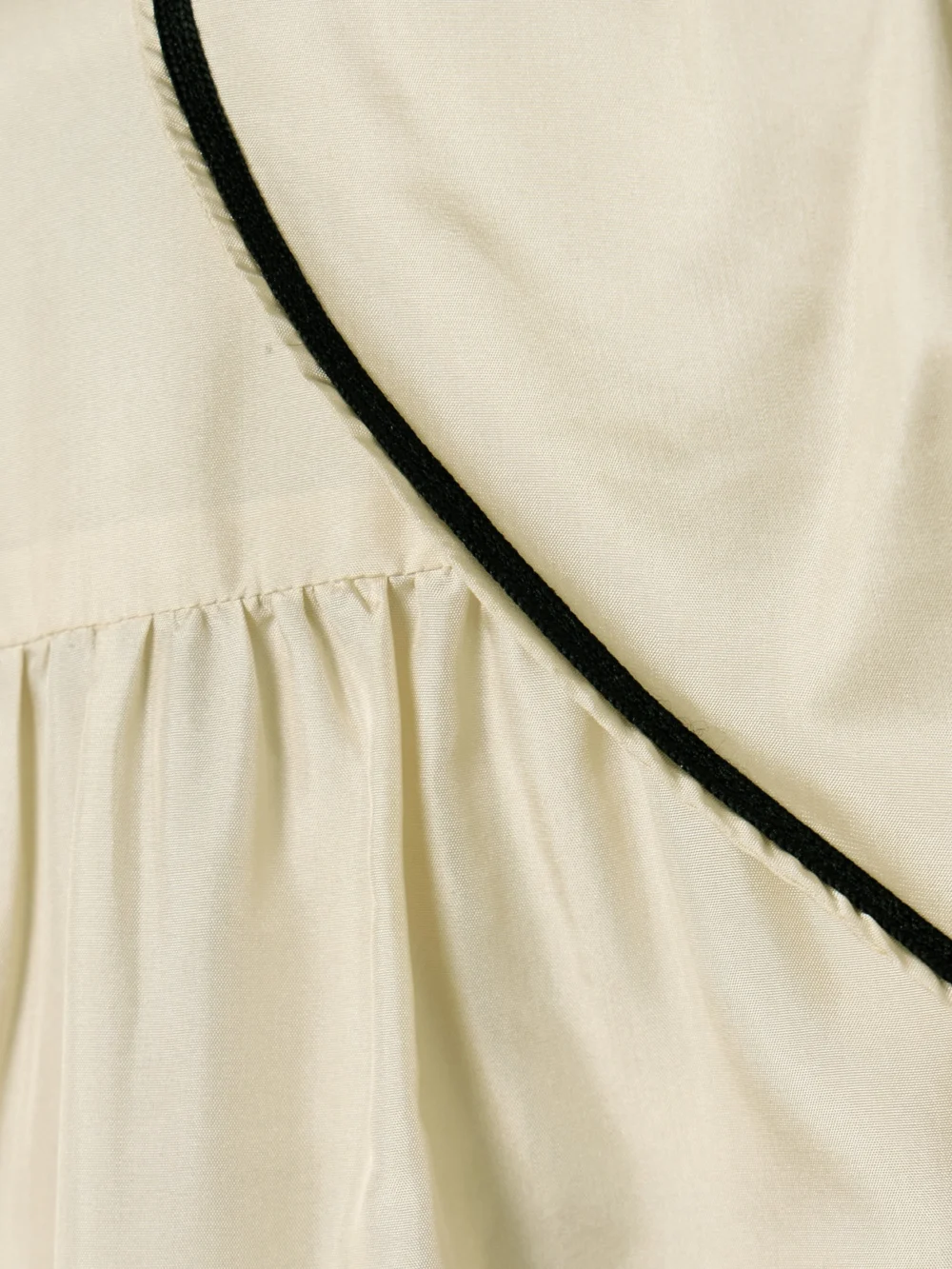 Close-up detail of the Bode Boater Belted Silk-satin Mini Dress