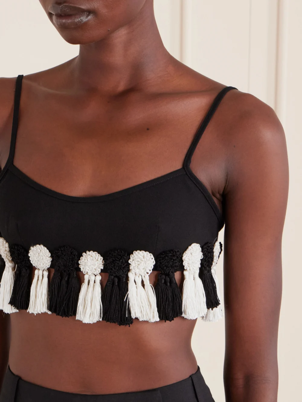 Close-up detail of the Bode Folly Tasseled Wool-crepe Bralette