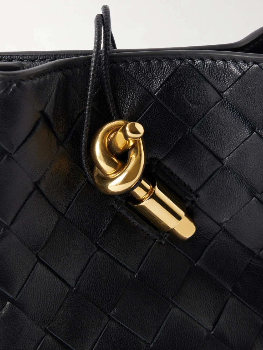 Close-up detail of the Bottega Veneta Andiamo Intrecciato Leather Phone Pouch
