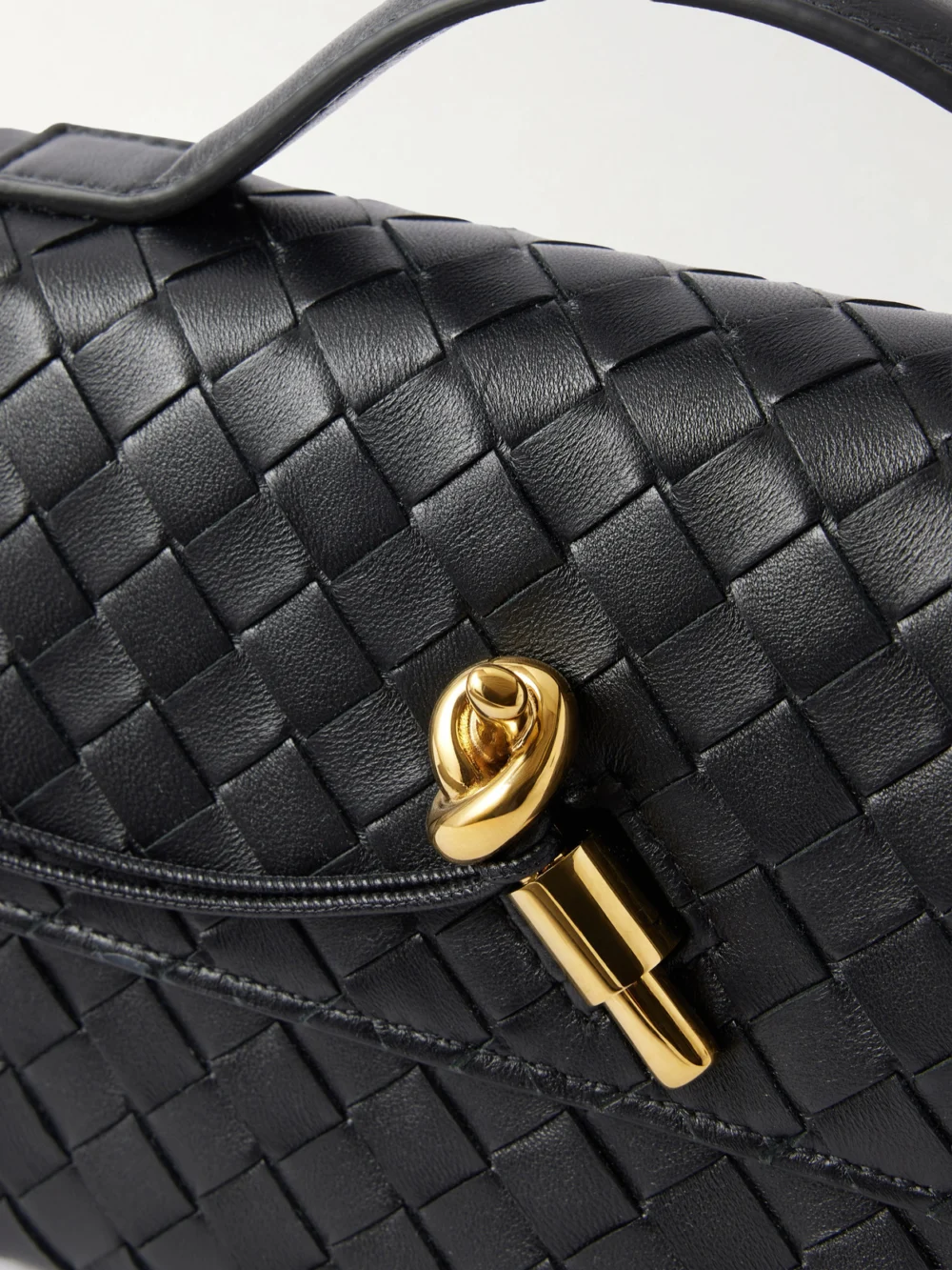 Close-up detail of the Bottega Veneta Andiamo Intrecciato Leather Top-handle Bag