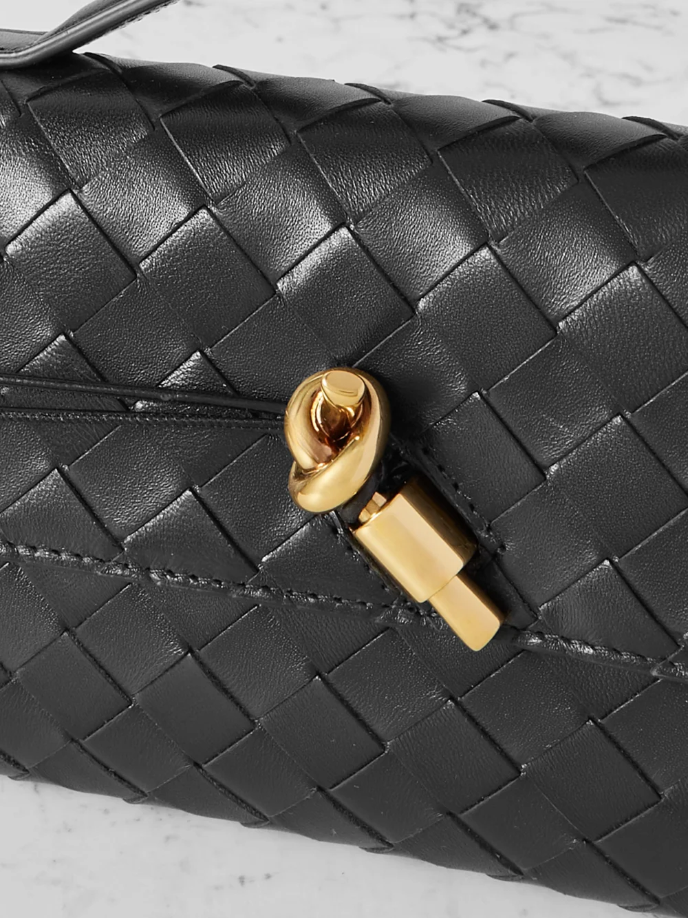 Close-up detail of the Bottega Veneta Andiamo Long Intrecciato Leather Clutch