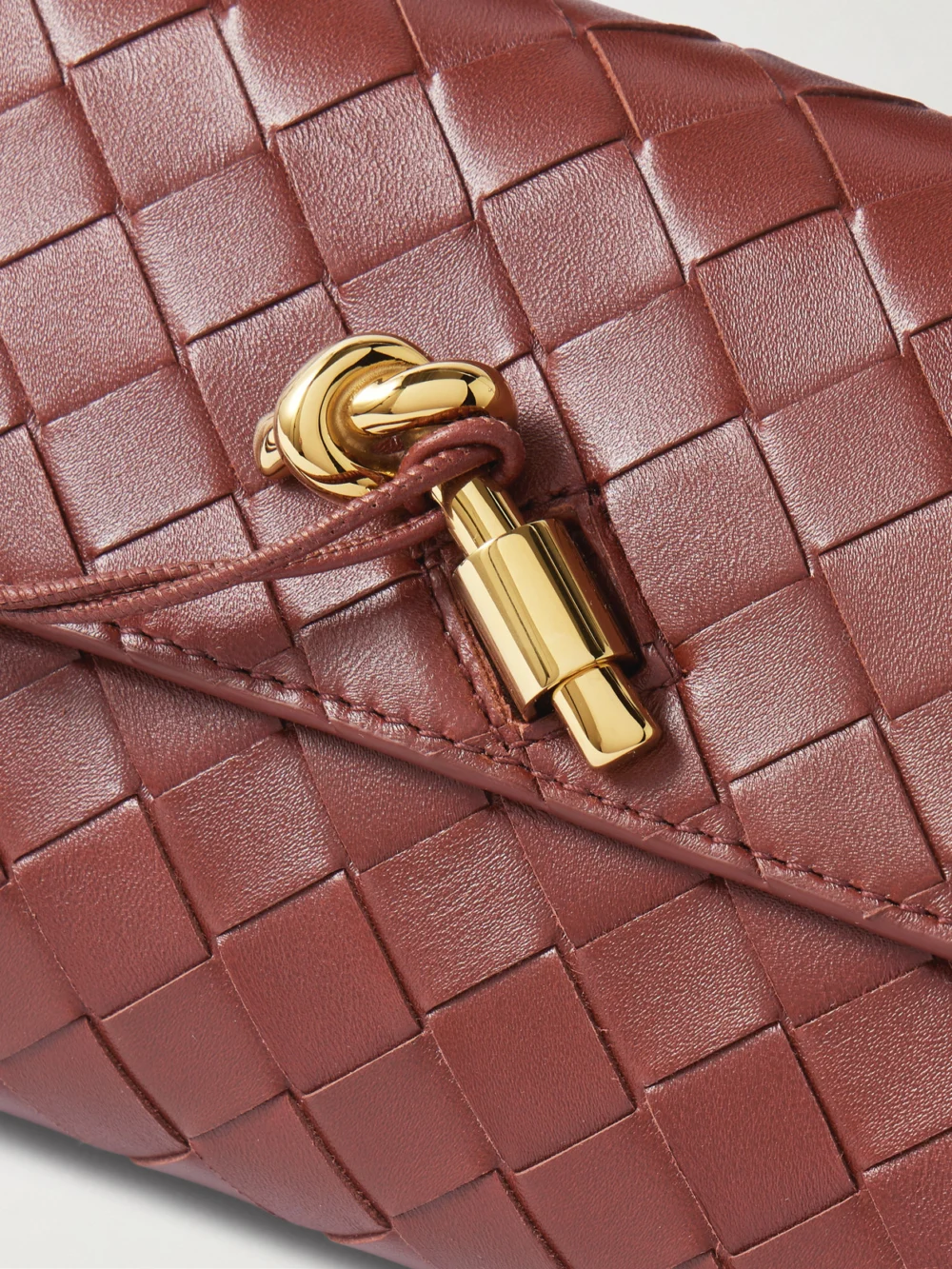 Close-up detail of the Bottega Veneta Andiamo Long Intrecciato Leather Clutch