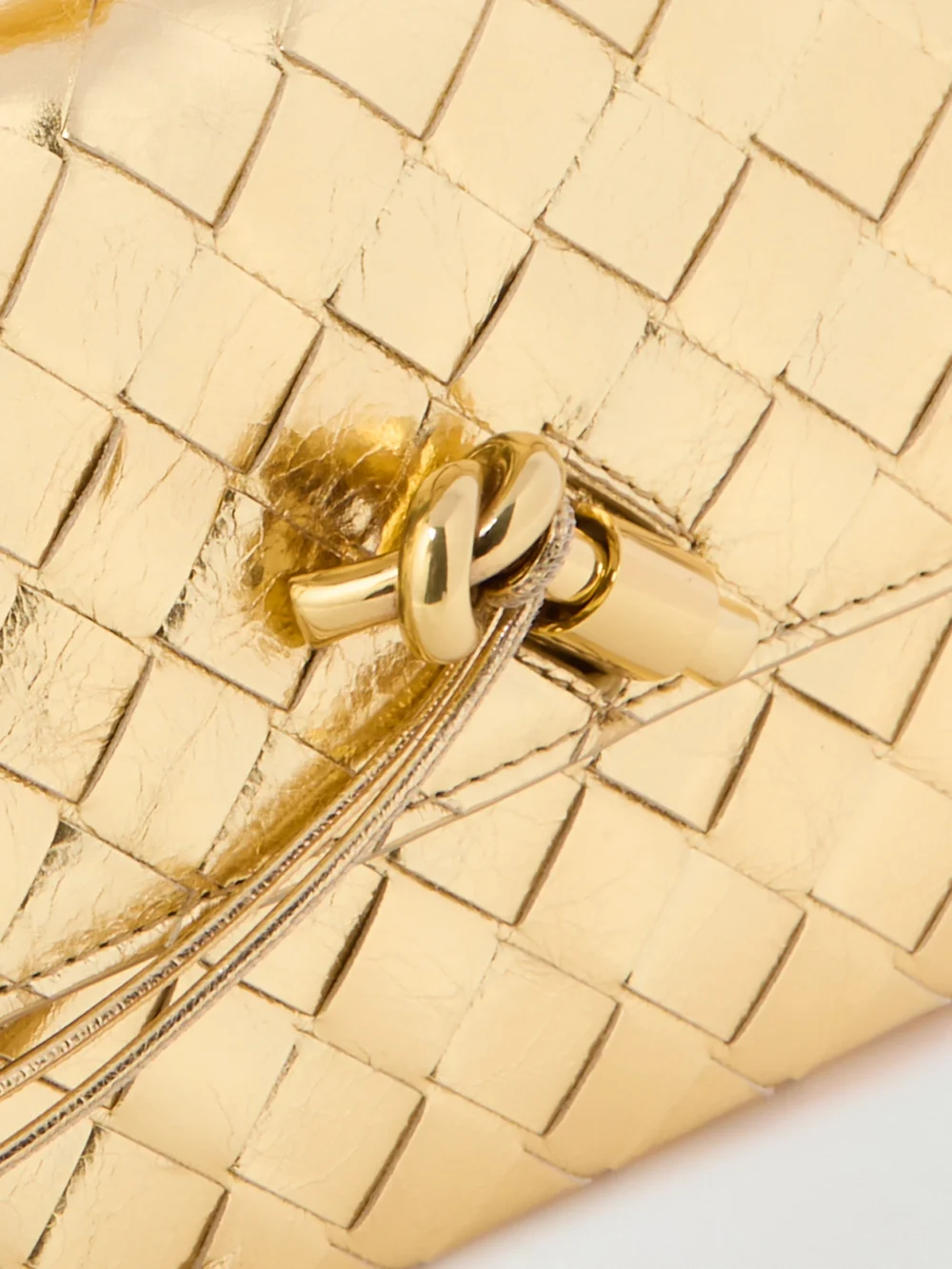 Close-up detail of the Bottega Veneta Andiamo Long Intrecciato Metallic Leather Clutch