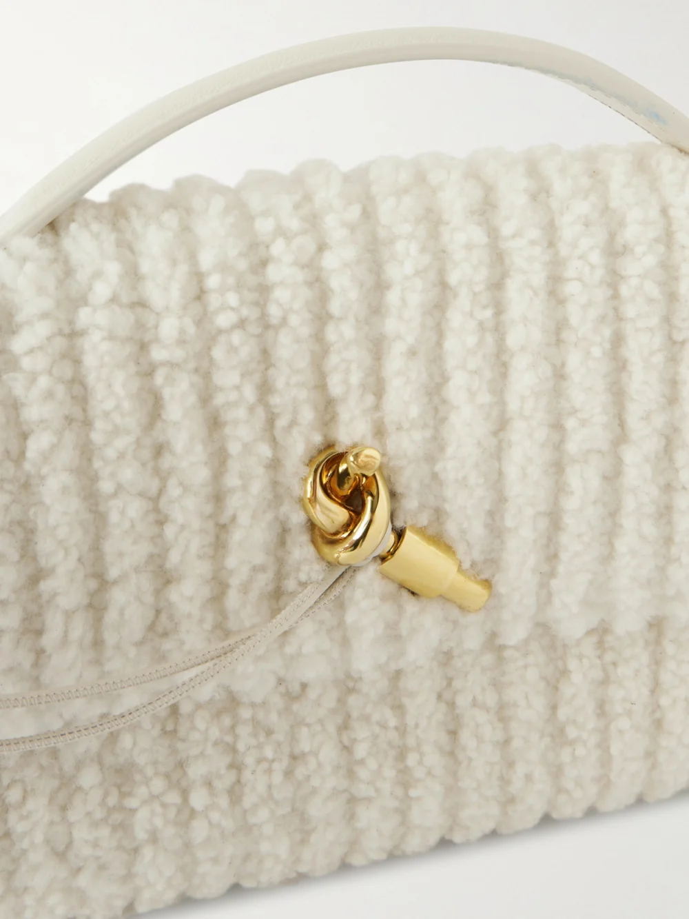 Close-up detail of the Bottega Veneta Andiamo Long Leather-trimmed Ribbed Bouclé Clutch
