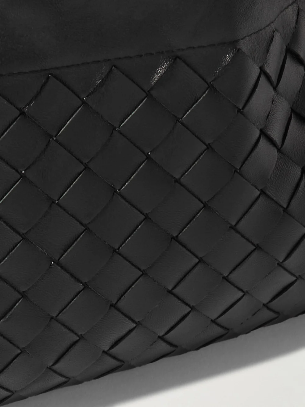 Close-up detail of the Bottega Veneta Dustbag Chain-embellished Intrecciato Leather Pouch