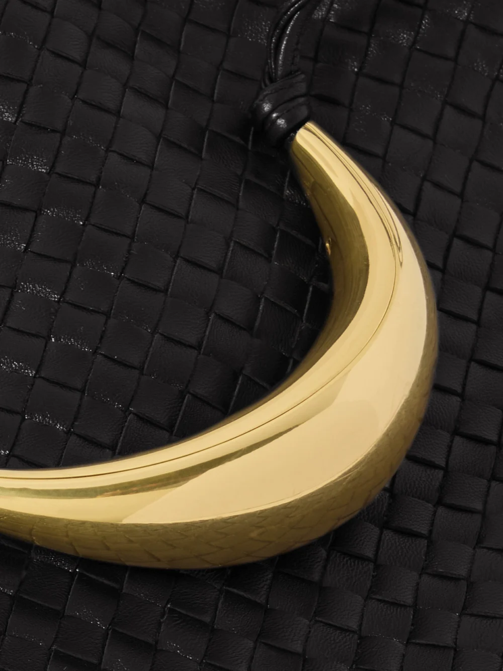 Close-up detail of the Bottega Veneta Dustbag Embellished Intrecciato Leather Pouch