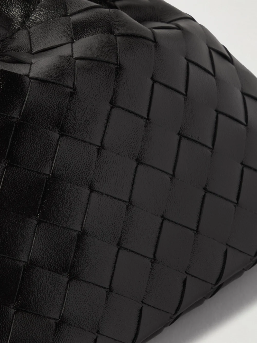 Close-up detail of the Bottega Veneta Dustbag Mini Intrecciato Leather Pouch