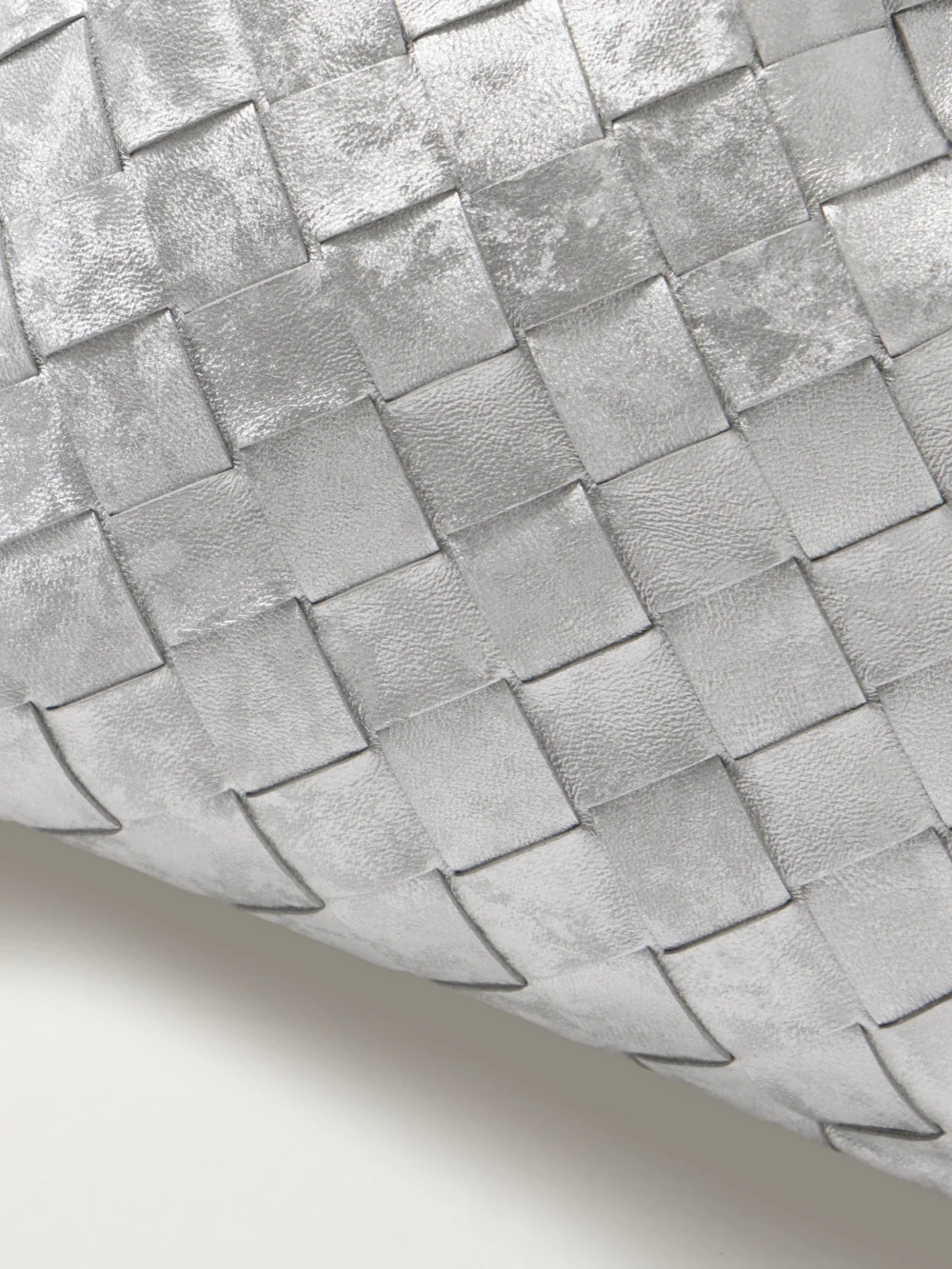 Close-up detail of the Bottega Veneta Dustbag Small Intrecciato Metallic Leather Pouch