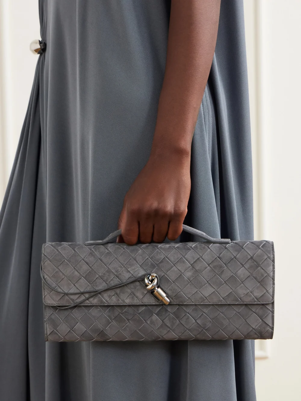 Bottega Veneta Intrecciato Suede Clutch, styled view