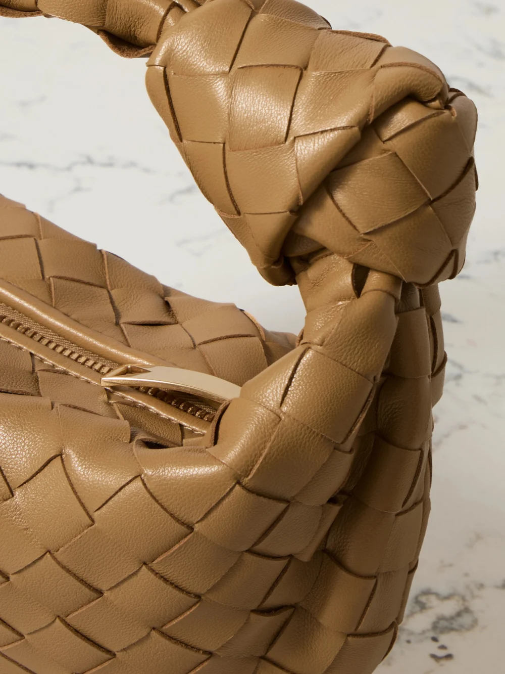 Close-up detail of the Bottega Veneta Jodie Mini Intrecciato Leather Tote