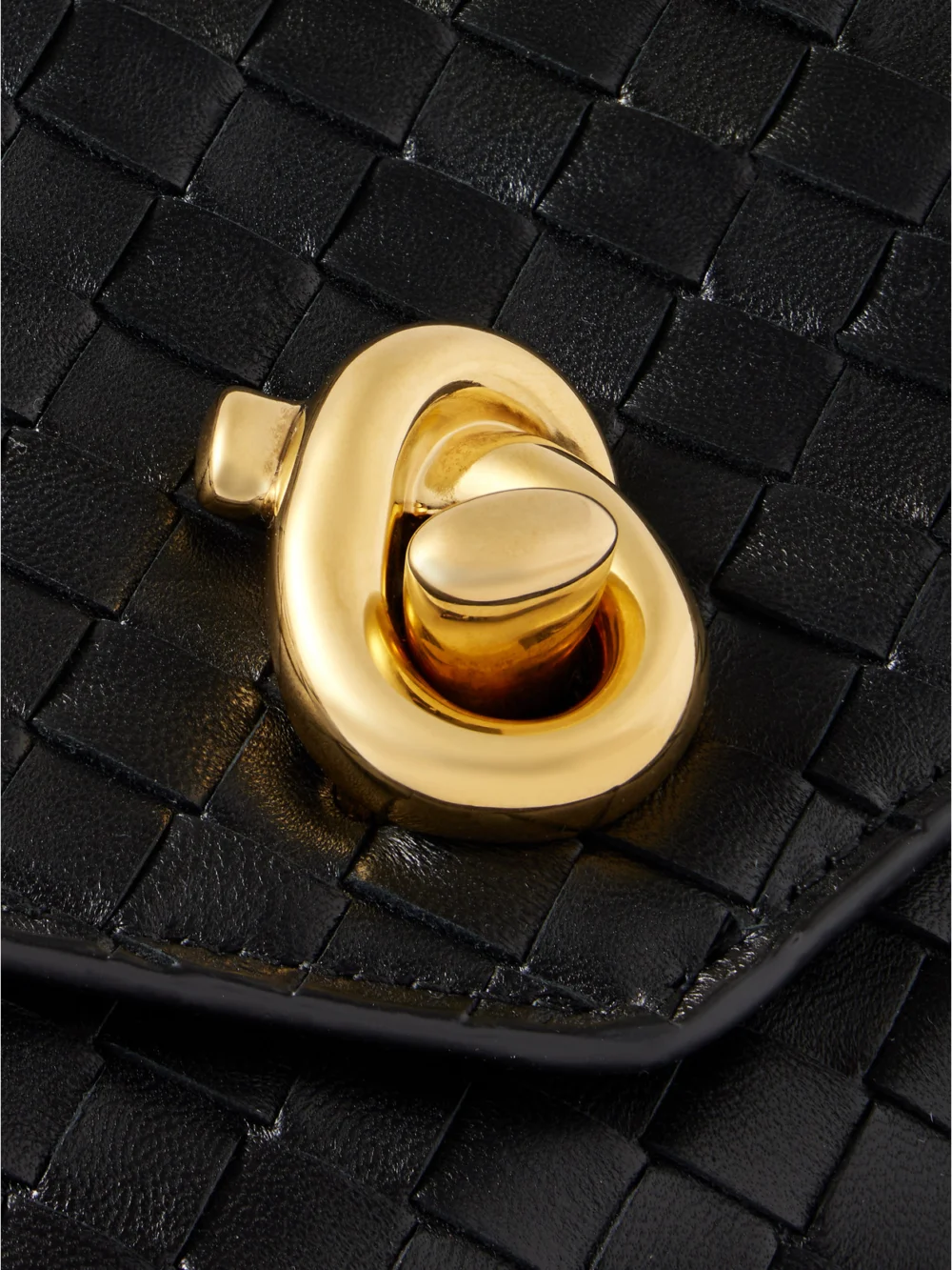 Close-up detail of the Bottega Veneta Knot Lock Medium Intrecciato Leather Top-handle Bag
