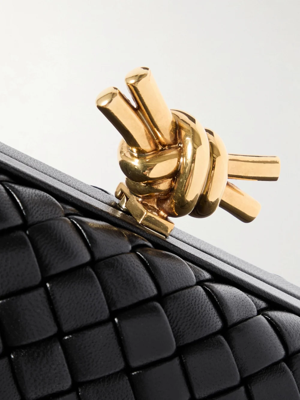 Close-up detail of the Bottega Veneta Knot Padded Intrecciato Leather Clutch