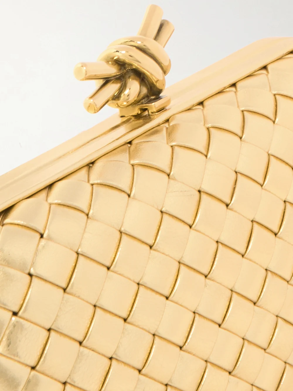 Close-up detail of the Bottega Veneta Knot Padded Intrecciato Metallic Leather Clutch