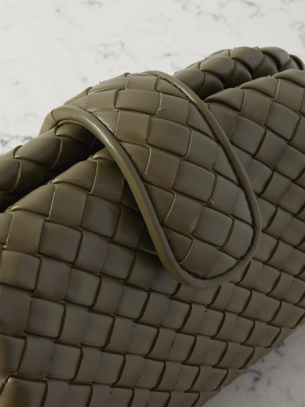 Close-up detail of the Bottega Veneta Lauren 1980 Small Intrecciato Leather Clutch