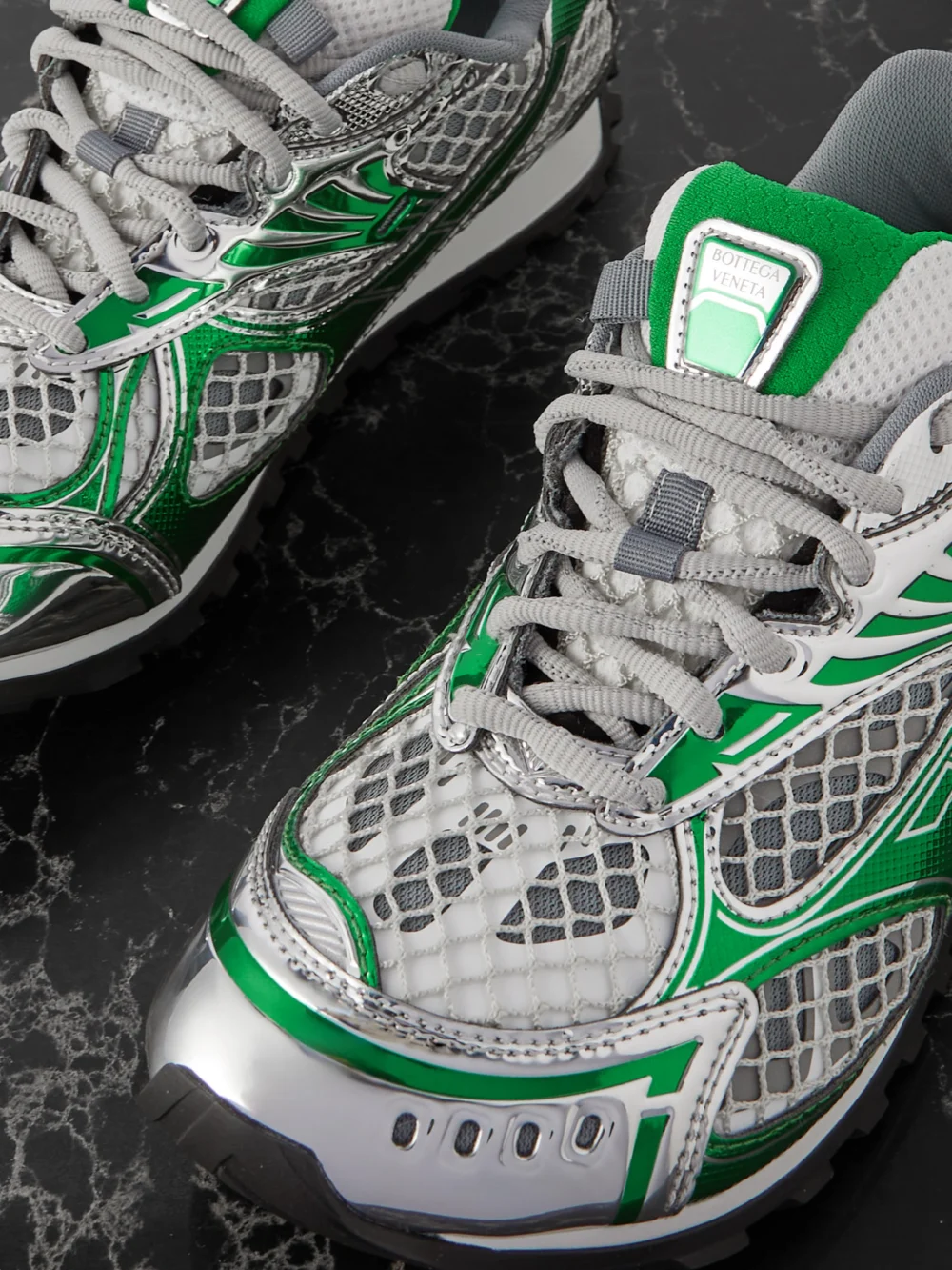 Close-up detail of the Bottega Veneta Orbit Metallic Rubber, Mesh and Fishnet Sneakers