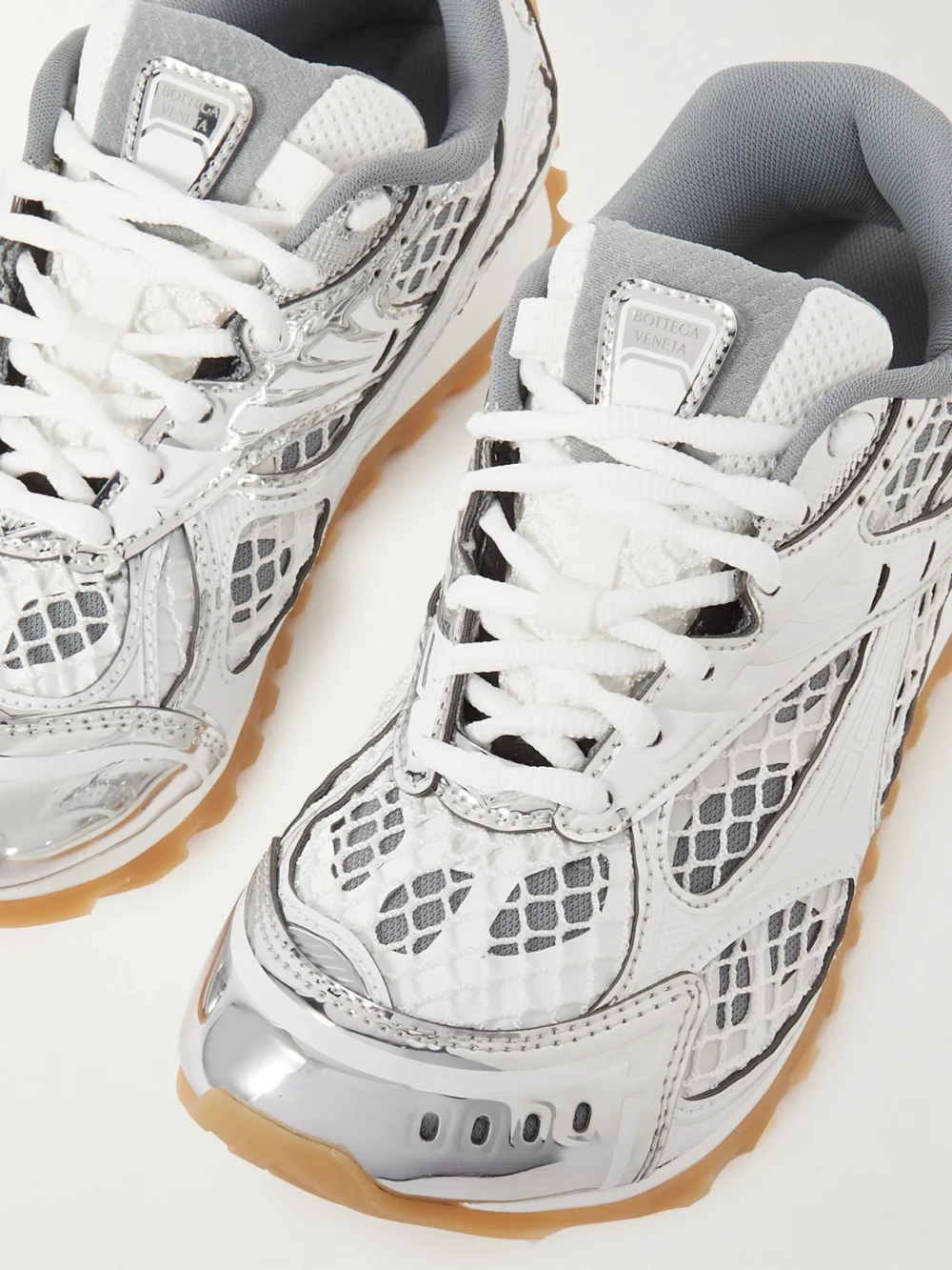 Close-up detail of the Bottega Veneta Orbit Metallic Rubber, Mesh and Fishnet Sneakers