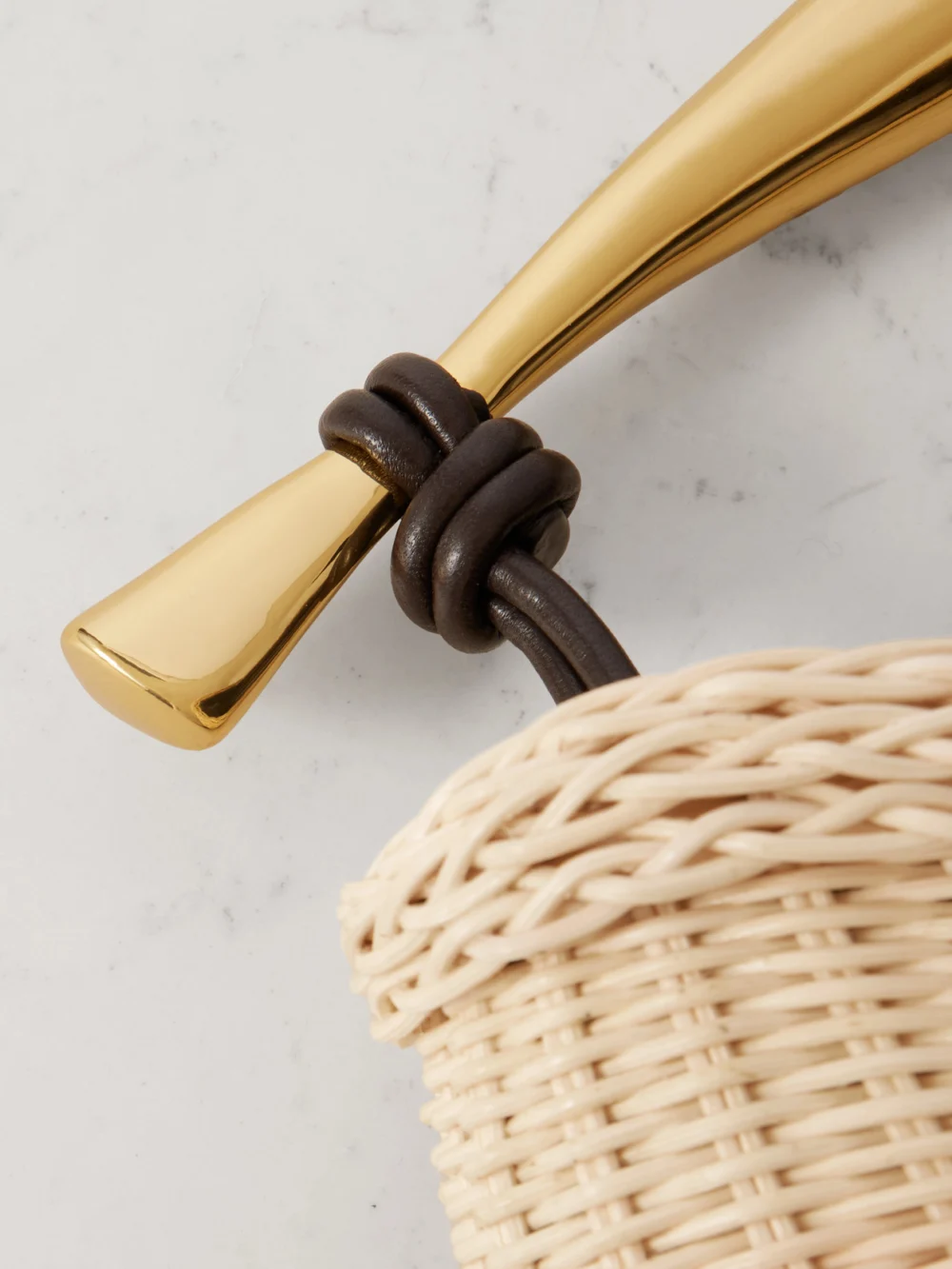 Close-up detail of the Bottega Veneta Sardine Small Leather-trimmed Raffia Tote
