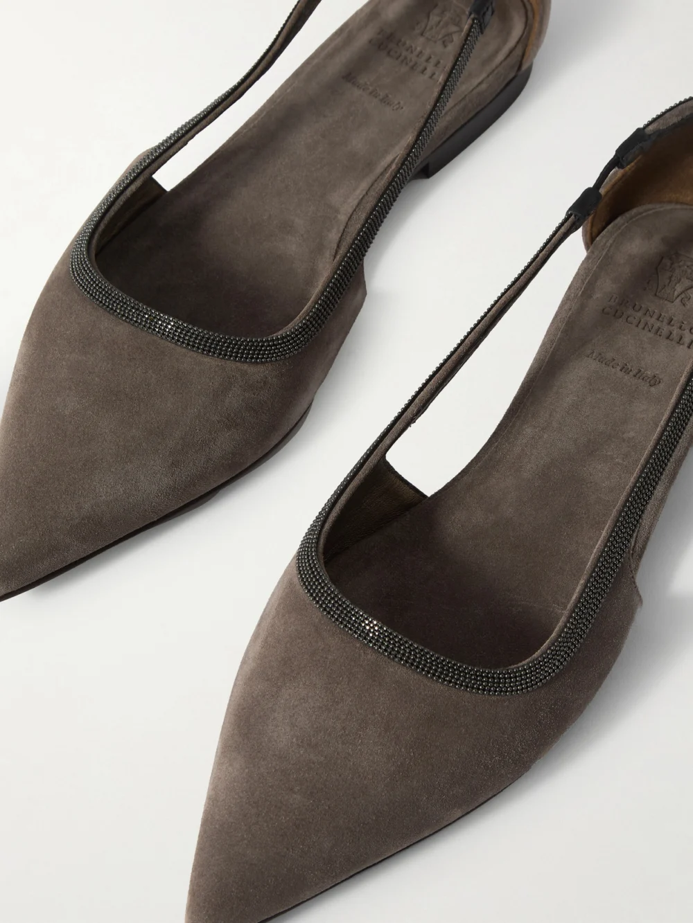 Close-up detail of the Brunello Cucinelli Bead-embellished Suede Point-toe Flats