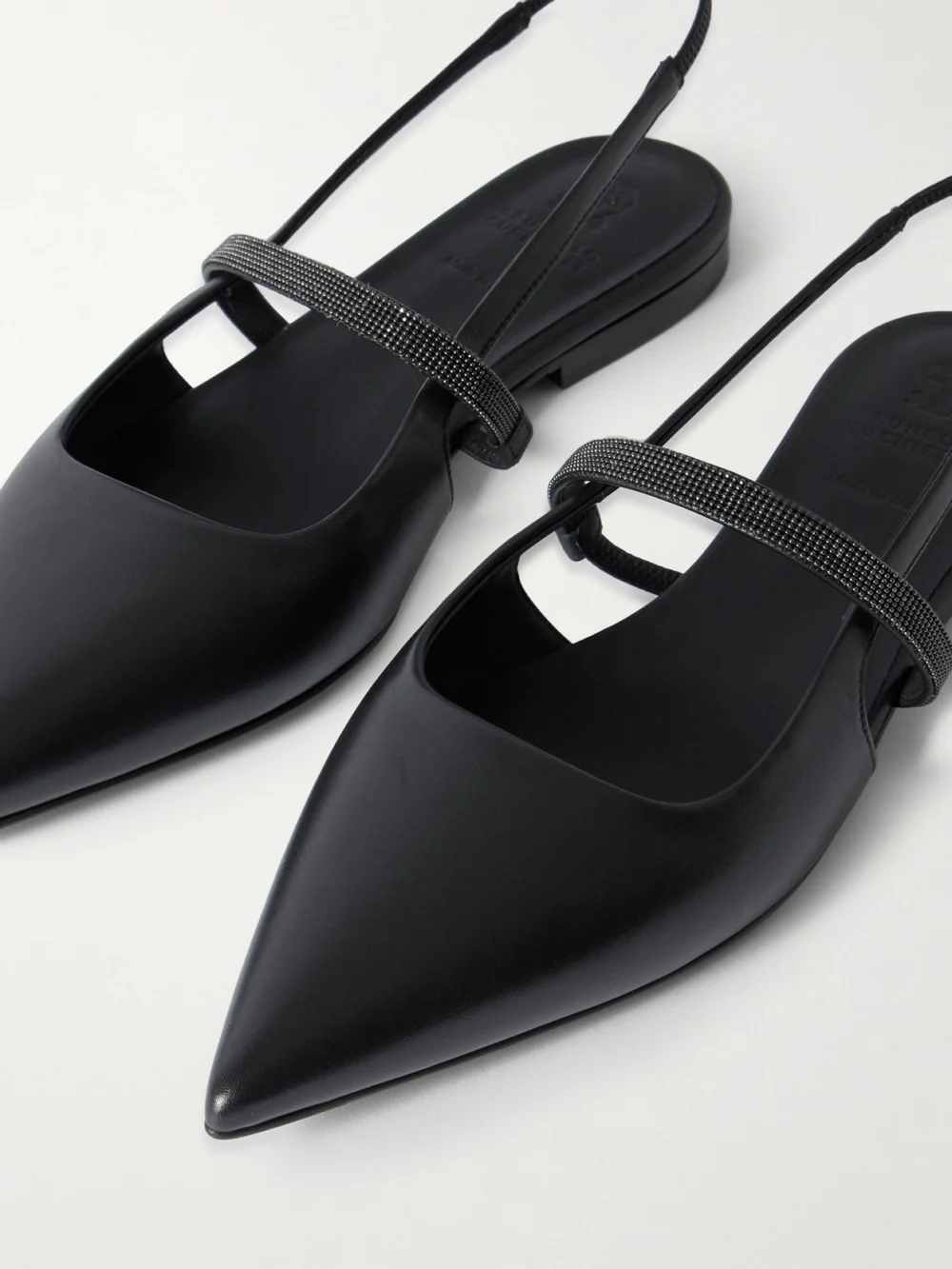 Close-up detail of the Brunello Cucinelli Embellished Cutout Leather Slingback Ballet Flats