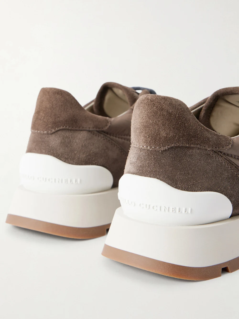 Close-up detail of the Brunello Cucinelli Monilli Runner Bead-embellished Shell and Suede Sneakers