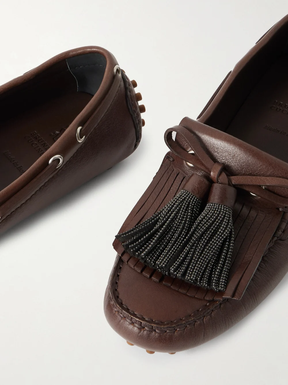 Close-up detail of the Brunello Cucinelli Tasseled Fringed Bead-embellished Leather Loafers