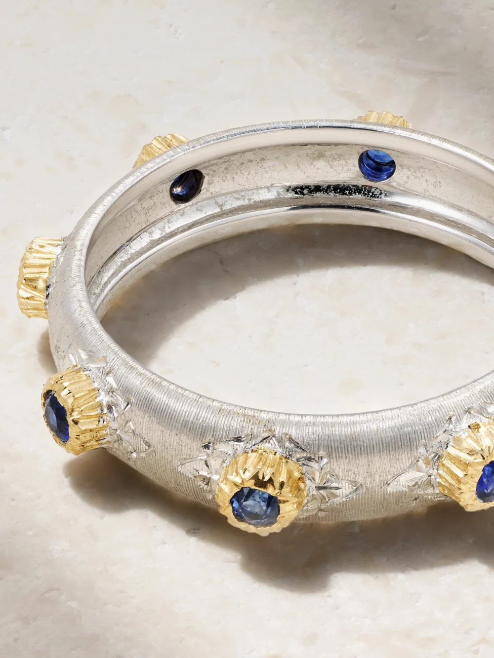 Close-up detail of the Buccellati Eternelle Fusi 18-karat White and Yellow Gold Sapphire Ring