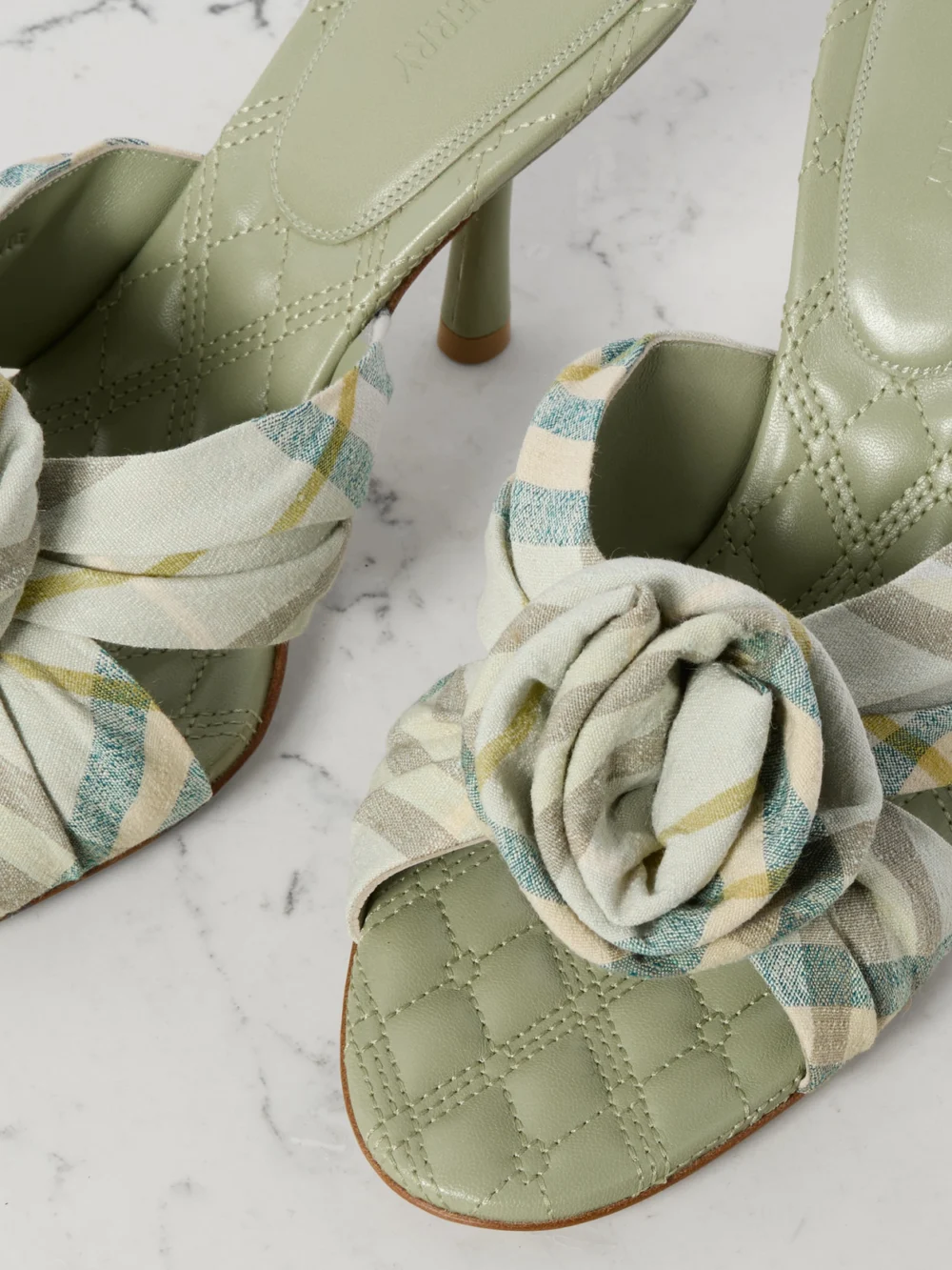 Close-up detail of the Burberry Appliquéd Checked Stretch-linen Mules