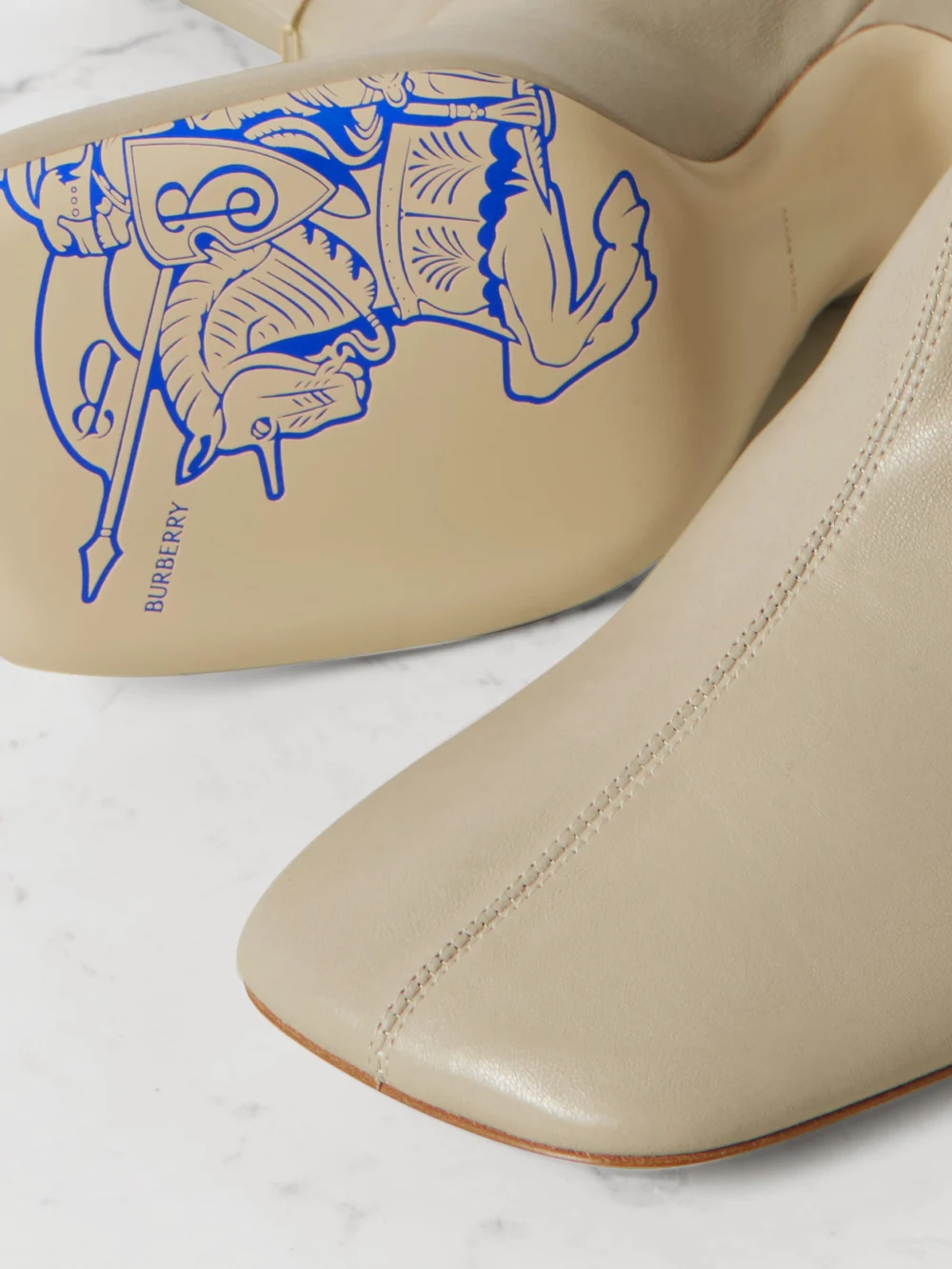 Close-up detail of the Burberry Chain-embellished Leather Ankle Boots