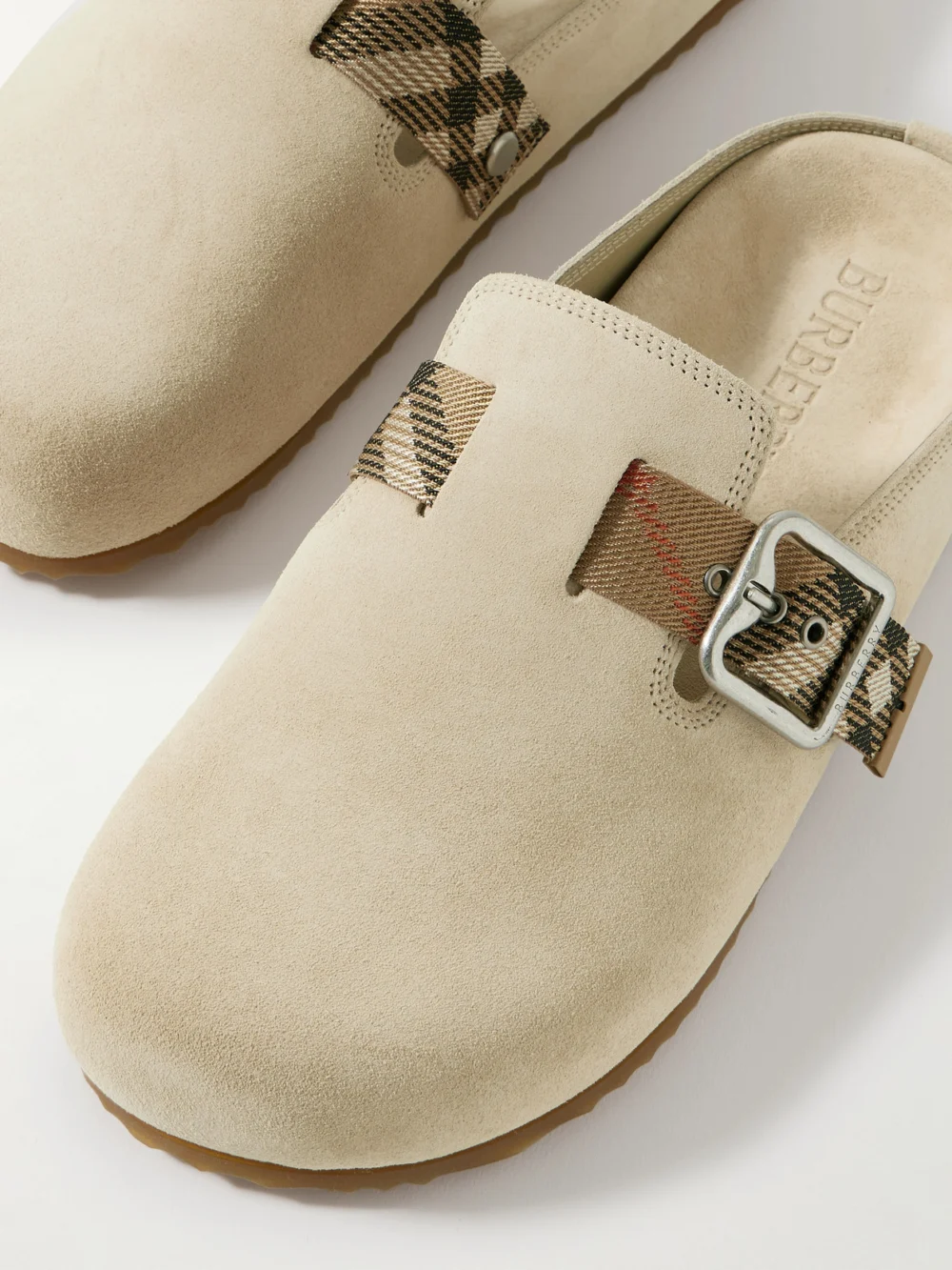Close-up detail of the Burberry Checked Jacquard-trimmed Buckled Suede Clogs