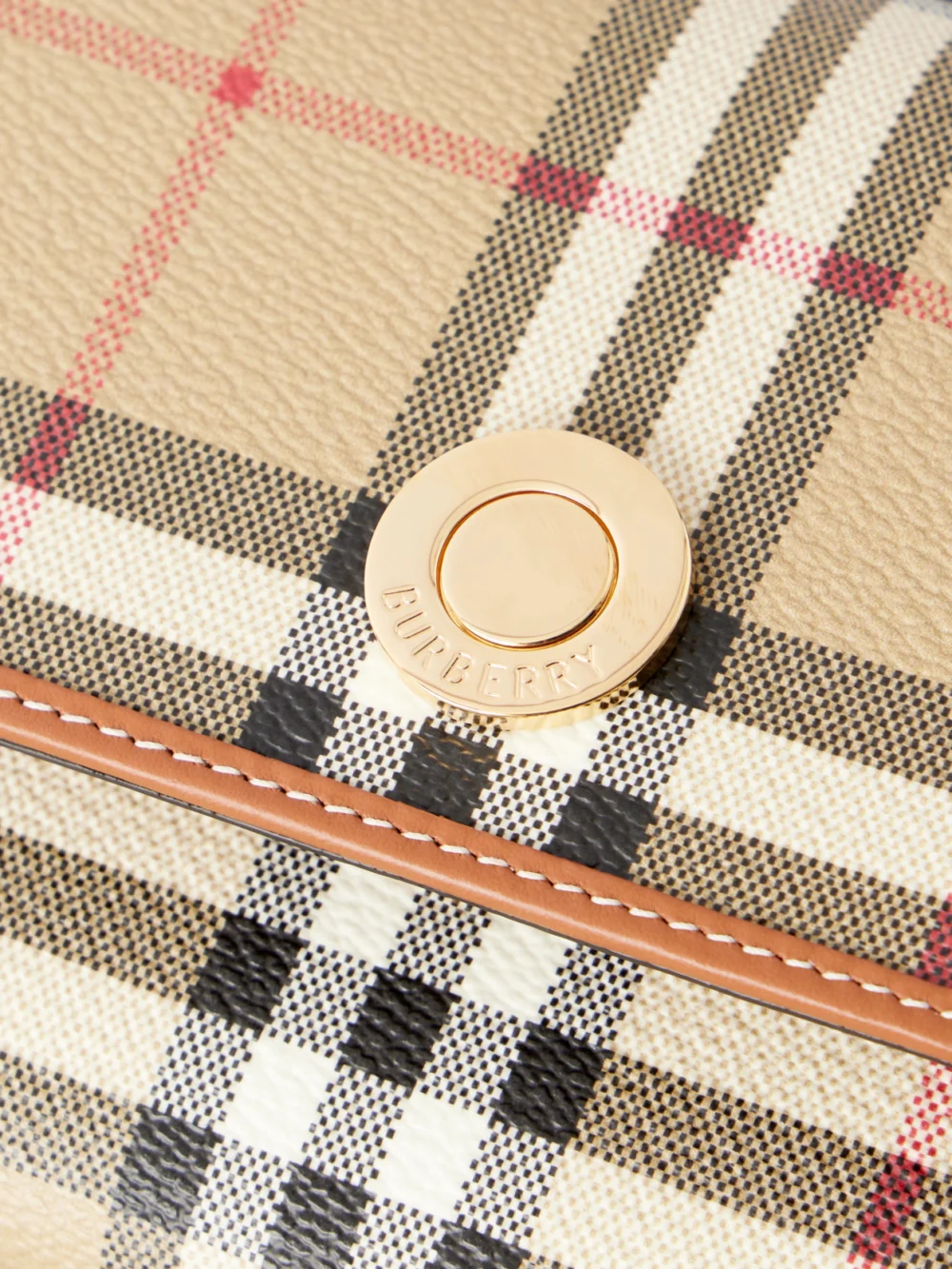 Close-up detail of the Burberry Checked Leather-trimmed Coated Canvas Clutch