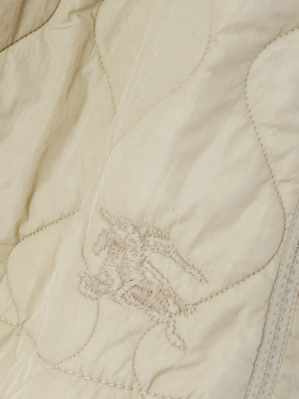 Close-up detail of the Burberry Embroidered Padded Quilted Shell Mini Skirt