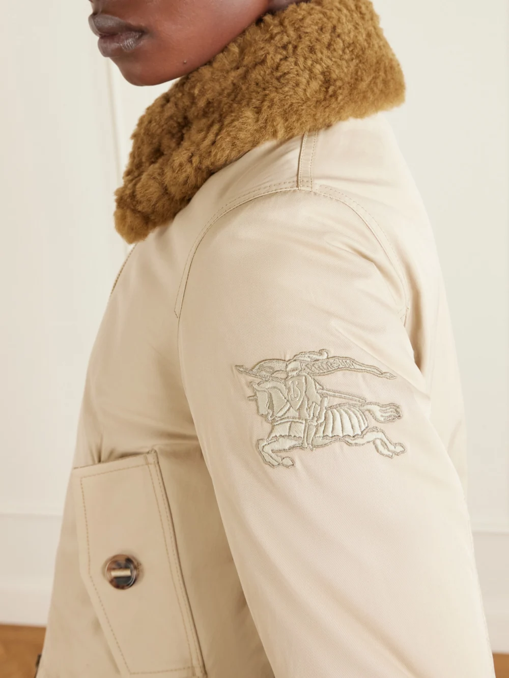 Close-up detail of the Burberry Gabardine Capsule Shearling-trimmed Appliquéd Cotton-blend Down Jacket