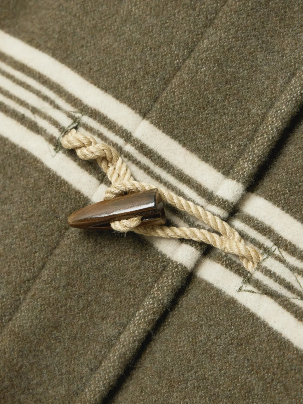 Close-up detail of the Burberry Hooded Striped Wool and Cotton-blend Coat